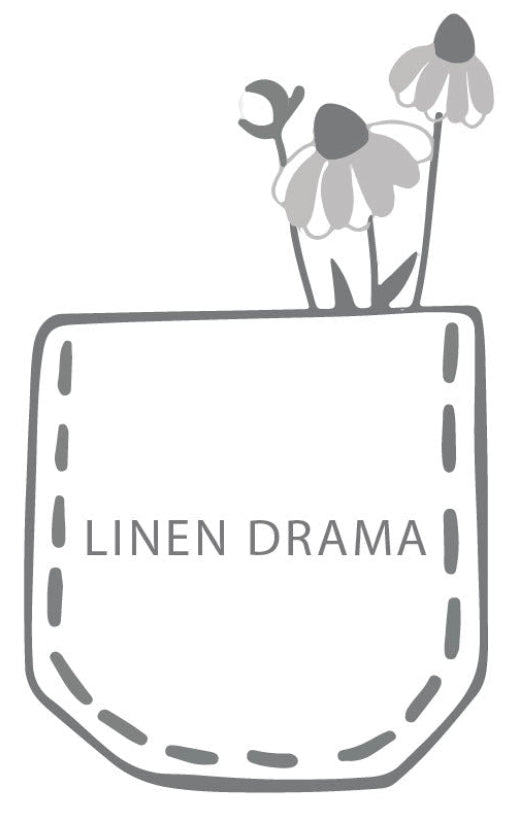 Pocket with flowers and 'Linen Drama' text on a white background